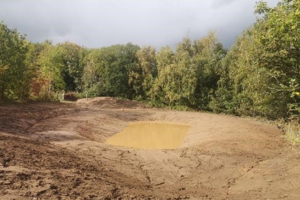 Brookhill Pond site restoration project. Buckley. Membrane laid, water is starting to be added to pond cavity.